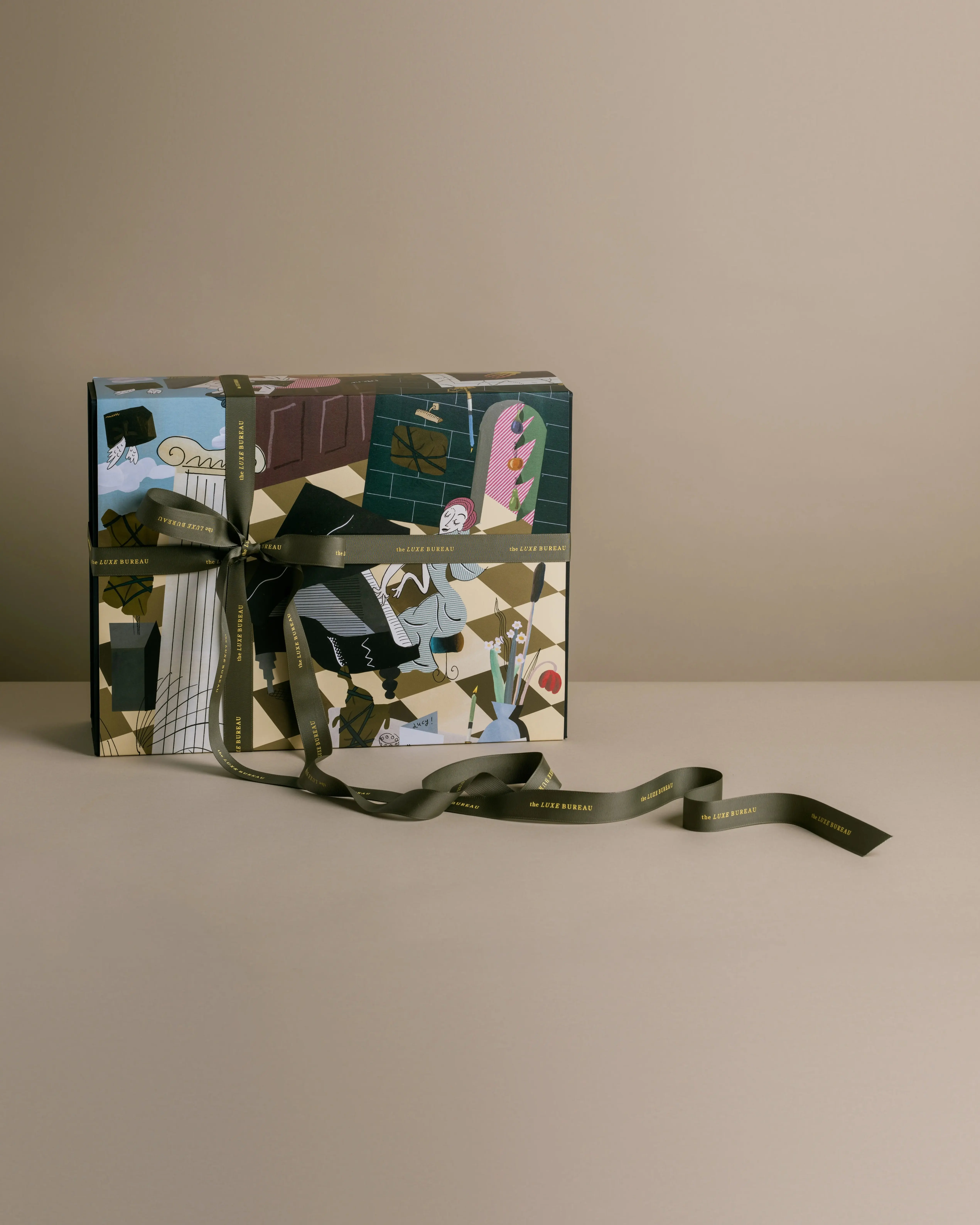 The Season festive gift box by the Luxe Bureau, in a sleeve illustrated by Zebedee Helm and tied with ribbon